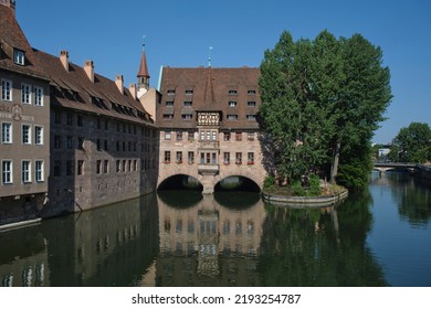 Nuremberg Landmark In Germany. Holy Spirit Hospital (Heilig-Geist-Spital) On River Pegnitz. Medieval Landmark.