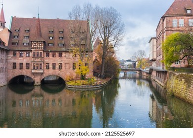 Nuremberg Landmark. Medieval Hospital Museum House Over Canal. Old Town Of Nuremberg, Germany. Tranquil Autumn Landscape In Old Town. Fall Season In Historical Downtown.