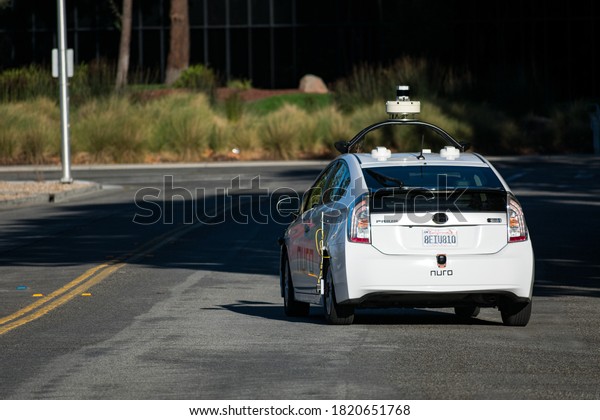 Nuro\
autonomous self-driving vehicle driving on a street in Silicon\
Valley - Santa Clara, California, USA -\
2020