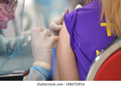 Nurse Administers A COVID-19 Vaccine To People At Indoor Stadium Huamark , Bangkok , Thailand , On 7 June 2021