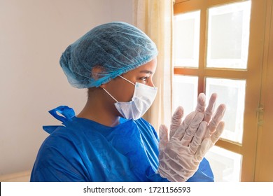 Nurse Applauding Through Hospital Window