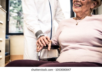 Nurse Assisting Patient In An Hospice