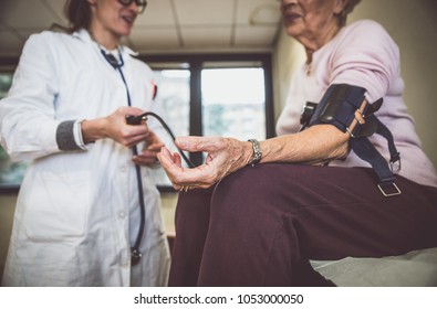 Nurse Assisting Patient In An Hospice