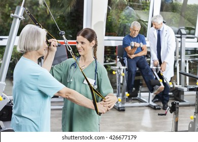 Nurse Assisting Senior Woman With Resistance Band Exercise - Powered by Shutterstock