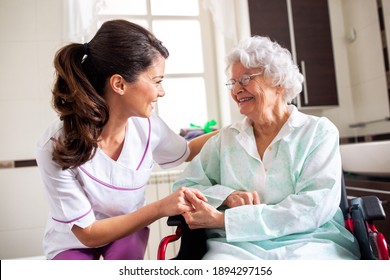 Nurse attending senior woman in a long term care facility, concept of trust between medical staff and home occupants - Shutterstock ID 1894297156