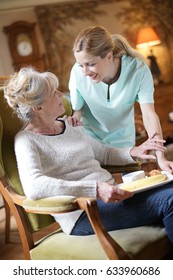 Nurse Bringing Breakfast To Senior Female Patient 