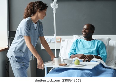 Nurse bringing lunch for patient - Powered by Shutterstock