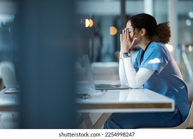 Nurse, burnout stress and black woman in hospital feeling pain, tired or sick on night shift. Healthcare, wellness and female medical physician with depression or anxiety while working late on laptop