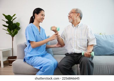 nurse or caregiver helping elderly patient to physiotherapist and exercise for rehabilitation at home - Shutterstock ID 2256846645