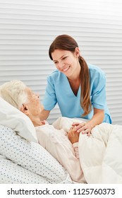 Nurse Cares For A Sick Elderly Woman In The Hospice Or At Home