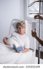 Nurse Is Changing Elderly Patient Iv Bag