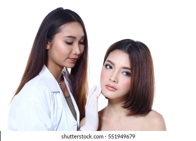 Nurse Check Woman's Face Who Want To Do Eye, Nose, Eyebrow, Forehead, Cheek, Jawline Before Plastic Surgery, Studio Lighting White Background Copy Space For Text Logo