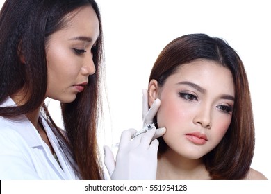 Nurse Check Woman's Face Who Want To Do Eye, Nose, Eyebrow, Forehead, Cheek, Jawline Before Plastic Surgery, Studio Lighting White Background Copy Space For Text Logo