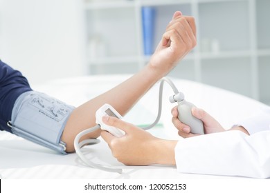 Nurse Checking Blood Pressure Of Her Patient