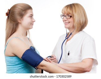 Nurse Is Checking Blood Pressure On Teenage Girl During A Medical Office Visit. 