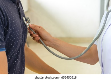 Nurse Is Checking Patient's Heart Using Stethoscope In Medical Check Up