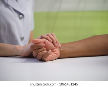 Nurse Checks Pulse Of Patient At Wrist . This Activity Is Necessary For Evaluation Her Heart Function .Pulse Is The One Of Vital Signs .