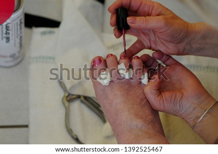 Nurse Cleans And Paints Seniors Toenails