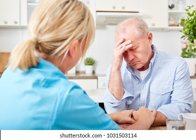 Nurse comforts senior man with dementia and depression