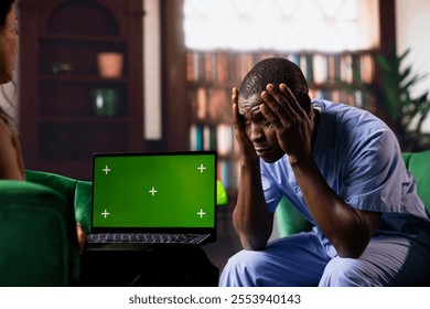 Nurse in counseling session next to green screen discussing stress and burnout, opening up about his career risks and struggles. Male medical assistant deals with emotional stress. - Powered by Shutterstock