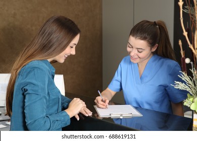 Nurse Or Dentist Attending A Client In A Clinic Reception