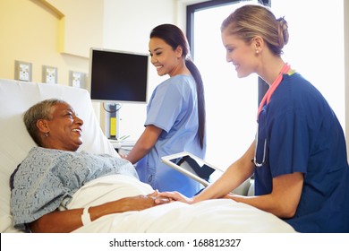 Nurse With Digital Tablet Talks To Woman In Hospital Bed - Powered by Shutterstock