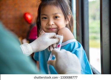 Nurse Doctor Holding Syringe Injection Immunization Asian Cute Girl Kid Patient In Hospital Health Care Vaccine Prevention Cold Flu  Examination Disease Concept 