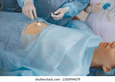 Nurse And Doctor Prepare Patient Skin For Surgery Using Antiseptic Solution 