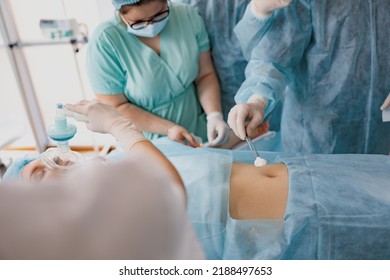 Nurse And Doctor Prepare Patient Skin For Surgery Using Antiseptic Solution 