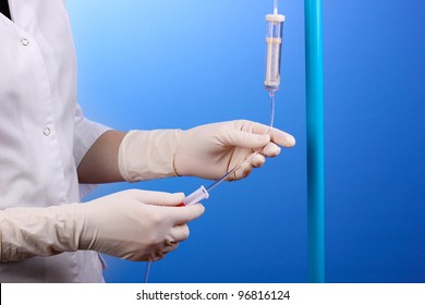 Nurse Doing Infusion On Blue Background