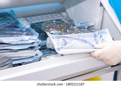 nurse doing sterilization of dental medical instruments in autoclave. Sterilization department at dental clinic - Shutterstock ID 1805211187