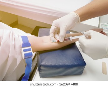 Nurse Drawing Blood A Patient By Syringe