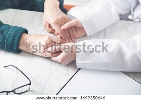 Similar – Female doctor filling out a questionnaire to senior patient