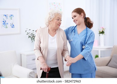 Nurse And Elderly Women In Light Room