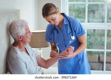 Nurse Examining Senior Man At Home