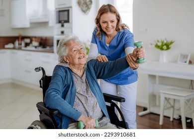 Nurse exercising with senior woman at her home, concept of healthcare and rehabilitation. - Powered by Shutterstock