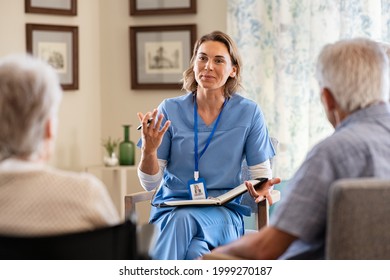 Nurse explaining to seniors at nursing home. Group of old men and women listening to young nurse on the change of therapy. Psychological support with counsellor therapist for a group of elderly people - Shutterstock ID 1999270187