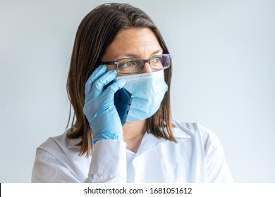 Nurse With Face Mask Calling On The Phone