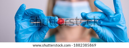 Nurse with facemask holding Coronavirus COVID-19 swab test kit, PPE protective mask and gloves, tube for taking OP NP patient specimen sample, PCR DNA RNA testing protocol process stock photo
