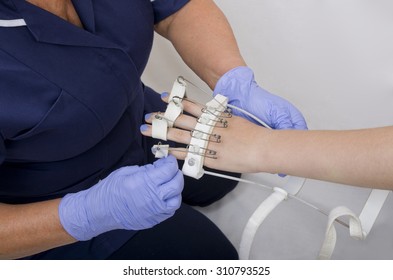 Nurse Fitting Girls Flexing Splint
A Teenage Girl With Injured Hand Having A Flexing Splint Fitted By A Nurse