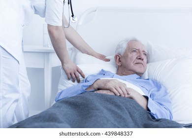Nurse fluffing pillow of elderly male patient at hospice - Shutterstock ID 439848337