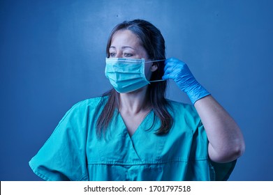 Nurse Getting Ready To Work In The Hospital Putting On Her Uniform And Mask