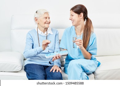 Nurse gives senior woman in nursing home or home medicine - Powered by Shutterstock