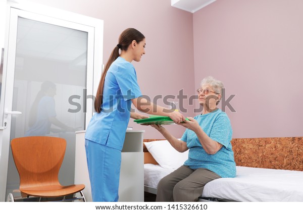 nurse-giving-food-senior-woman-hospital-stock-photo-edit-now-1415326610