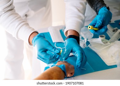 Nurse Giving Intravenous Medication To An Elderly Person In His Arm