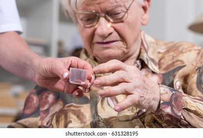 Nurse Giving Medication To An Old Woman