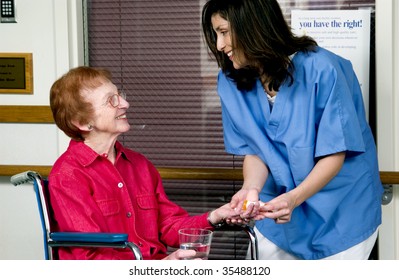 Nurse Giving Senior Woman Pills