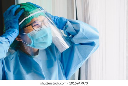 Nurse Having Headache And Tired From Work While Wearing PPE Suit For Protect Coronavirus Disease. The Wellbeing And Emotional Resilience Are Key Components Of Maintaining Essential Care Services.