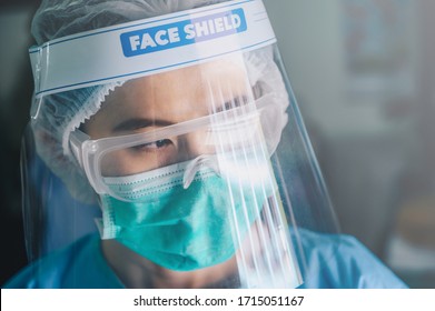 Nurse Having Tired From Work While Wearing PPE Suit For Protect Coronavirus Disease. PPE While Protecting Healthcare Workers From Exposure To The COVID-19 Virus In Healthcare Settings.