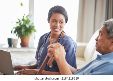 Nurse Help Senior Man With Internet And Laptop On The Sofa In A Retirement Home. Healthcare Worker, Caregiver Or Medical Professional Helping Retired Man With Email And Technology In The Lounge